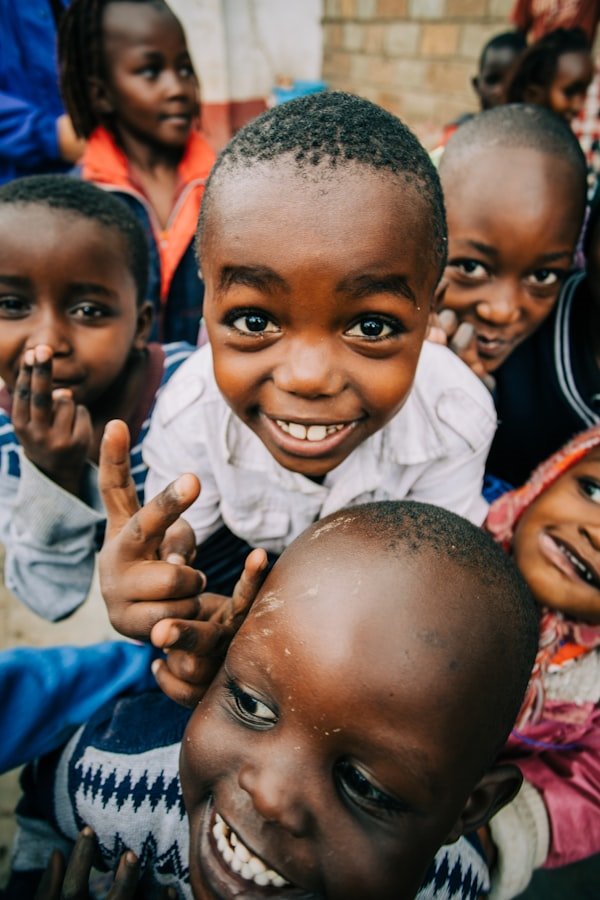 Children smiling at a tree-planting site