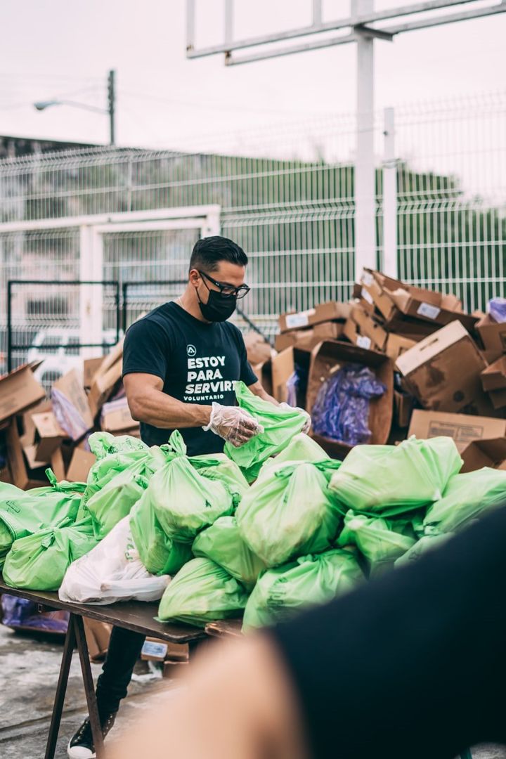 A volunteer sorting donated food and supplies for families in need